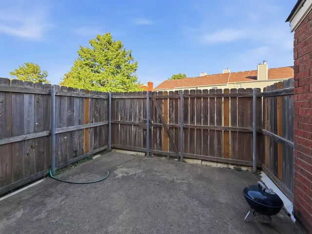 a view of a backyard with wooden fence