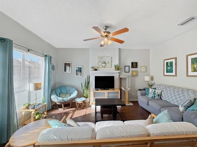 a living room with furniture a fireplace and a window