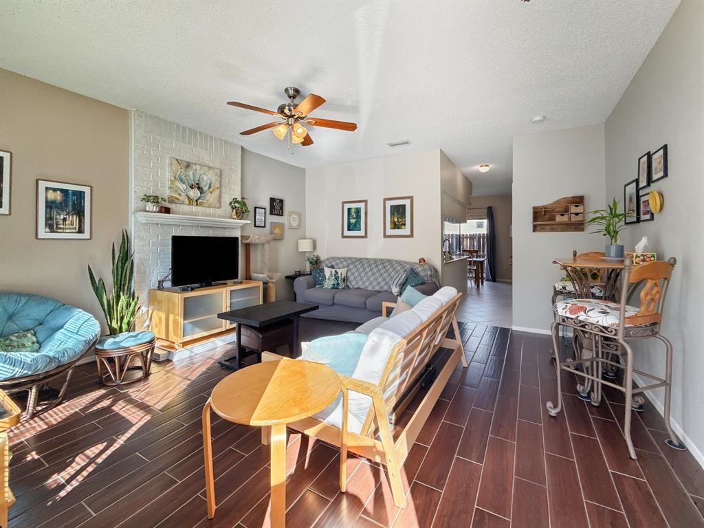 214 Samuel Boulevard, Unit 1H Coppell, TX 75019 - Photo 21 of 21 a living room with fireplace furniture and a flat screen tv