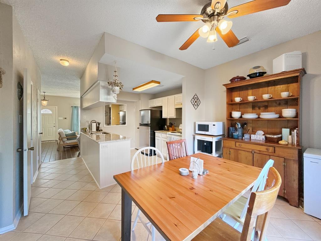 214 Samuel Boulevard, Unit 1H Coppell, TX 75019 - Photo 3 of 21 a view of a dining room with furniture and chandelier