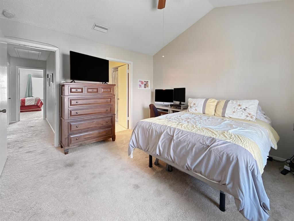 214 Samuel Boulevard, Unit 1H Coppell, TX 75019 - Photo 4 of 21 a bed room with a bed and a television