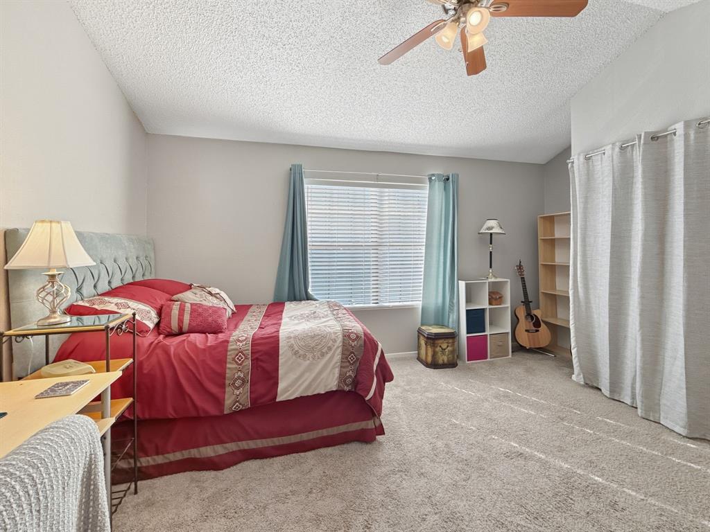 214 Samuel Boulevard, Unit 1H Coppell, TX 75019 - Photo 8 of 21 a bedroom with a bed and a large walk in closet