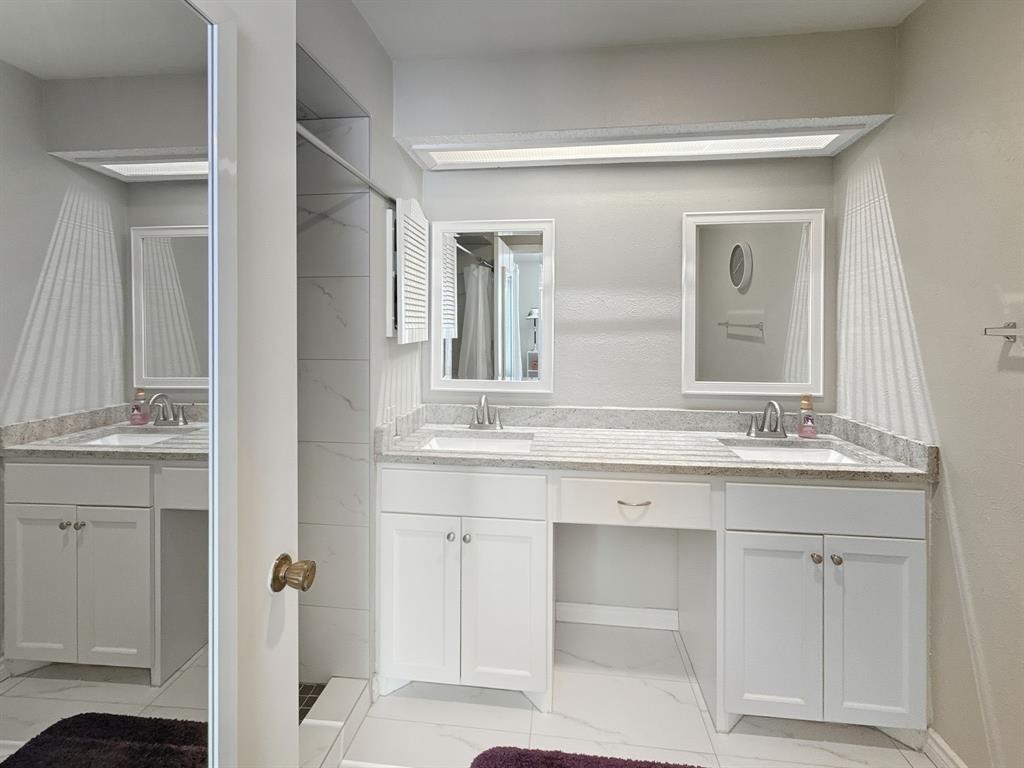 214 Samuel Boulevard, Unit 1H Coppell, TX 75019 - Photo 10 of 21 a bathroom with a sink and a mirror