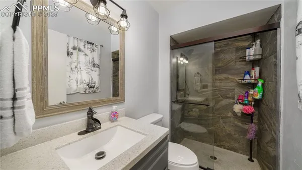 a bathroom with a sink toilet and shower