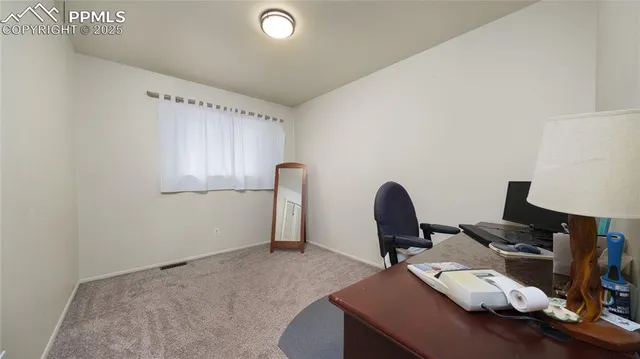 a workspace with furniture and window