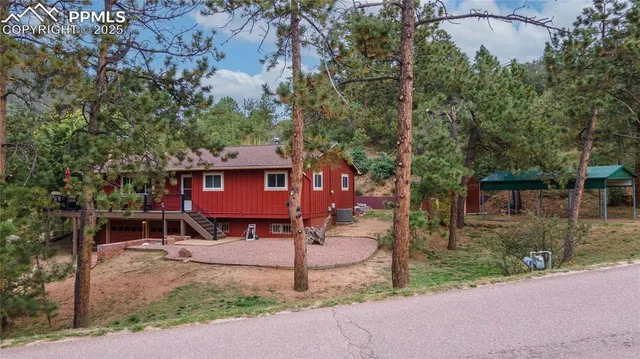 a red brick house with trees in front of it