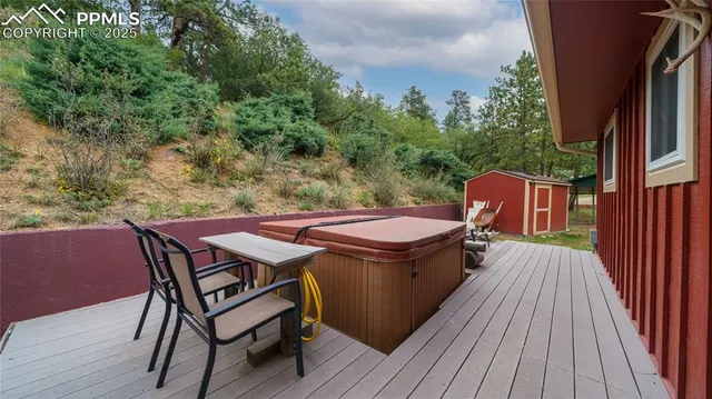 a view of a patio with table and chairs with wooden floor and fence