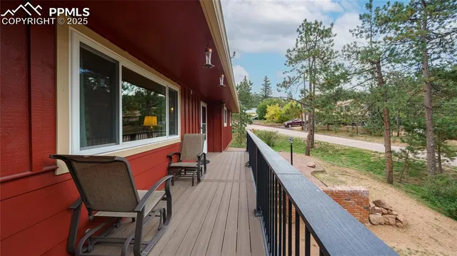 a balcony with wooden floor and outdoor seating