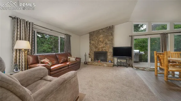 a living room with furniture window and a flat screen tv