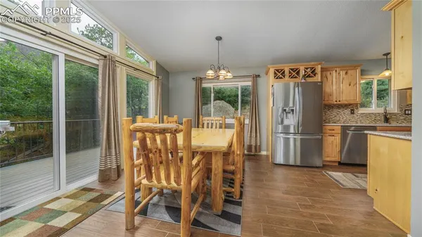 a dining room with furniture a chandelier and a rug