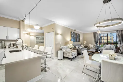 a kitchen with sink refrigerator and cabinets