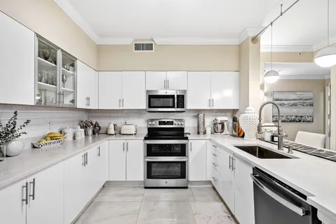 a kitchen with a sink cabinets and stainless steel appliances