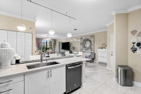 a kitchen with sink stove and refrigerator