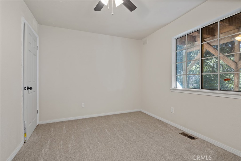 23561 Short Way Crestline, CA 92325 - Photo 14 of 18 an empty room with chandelier fan and windows