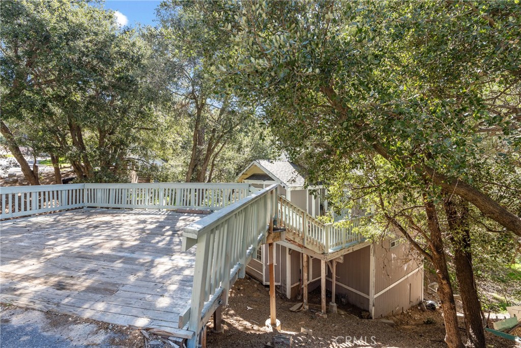 23561 Short Way Crestline, CA 92325 - Photo 16 of 18 a view of wooden house with large trees and wooden fence