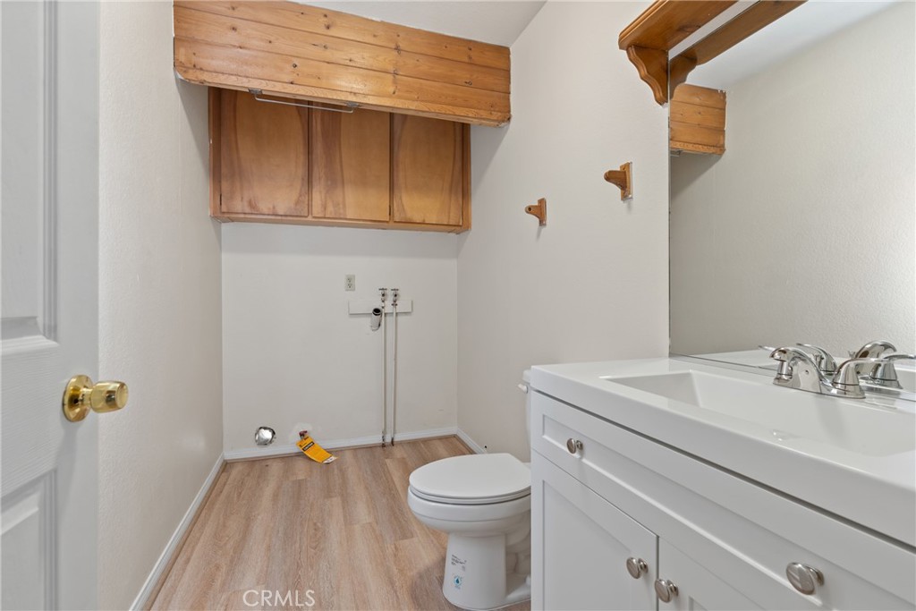 23561 Short Way Crestline, CA 92325 - Photo 9 of 18 a bathroom with a sink a toilet and a mirror