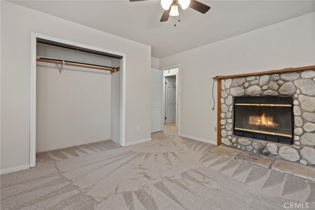 23561 Short Way Crestline, CA 92325 - Photo 10 of 18 a view of an empty room with chandelier fan and fire place