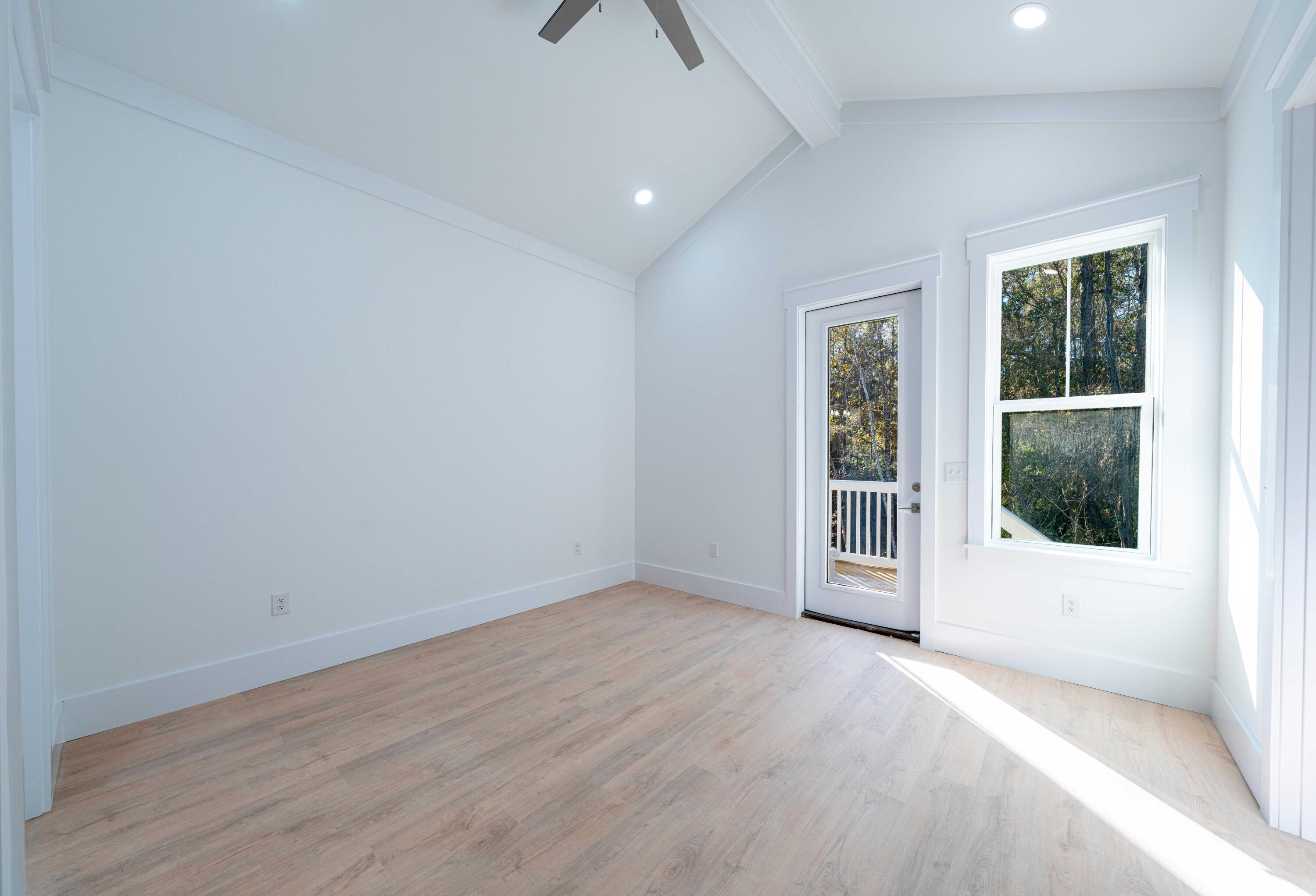 142 4th Street Santa Rosa Beach, FL 32459 - Photo 17 of 26 an empty room with wooden floor and windows