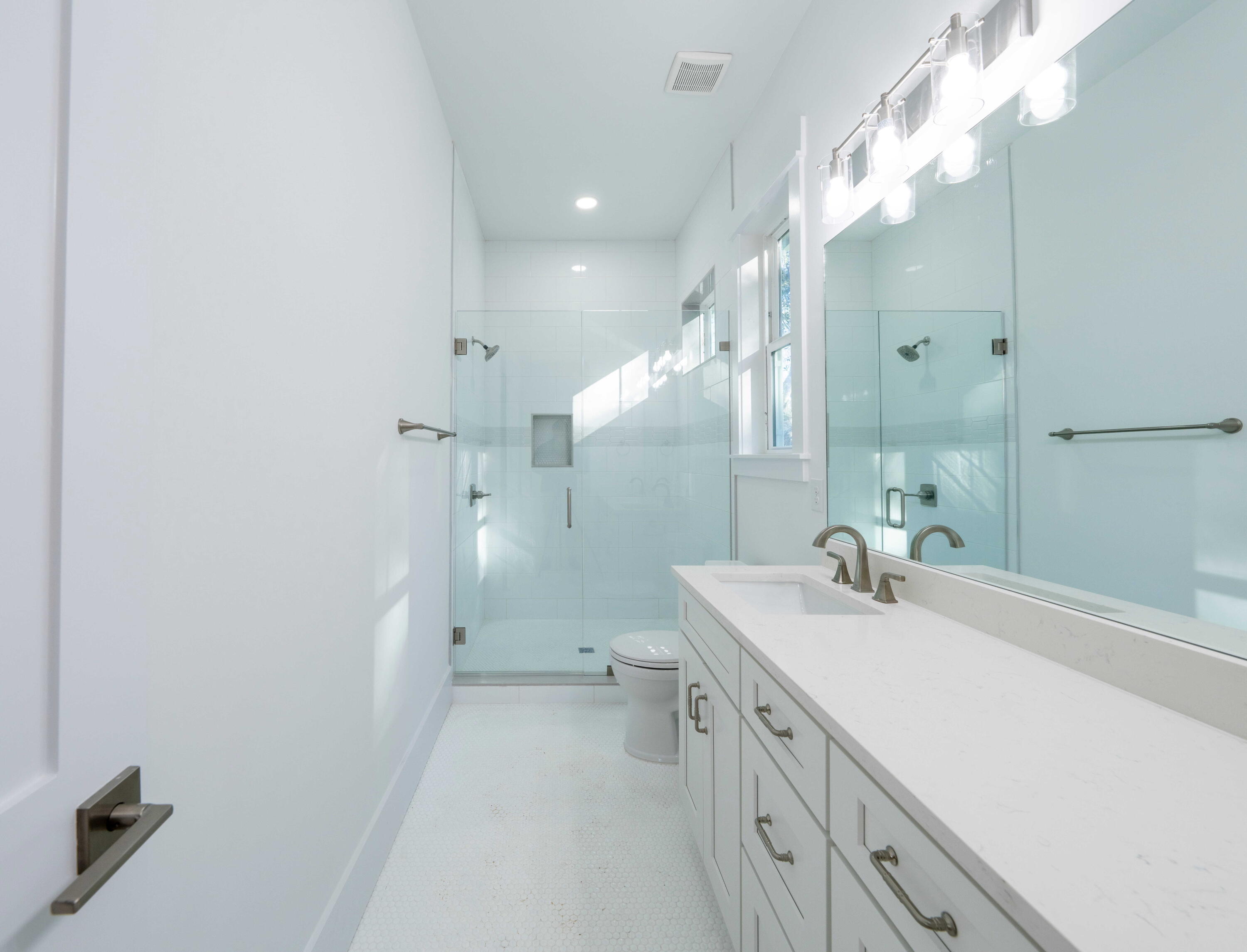 142 4th Street Santa Rosa Beach, FL 32459 - Photo 19 of 26 a bathroom with a sink a toilet a large mirror and shower