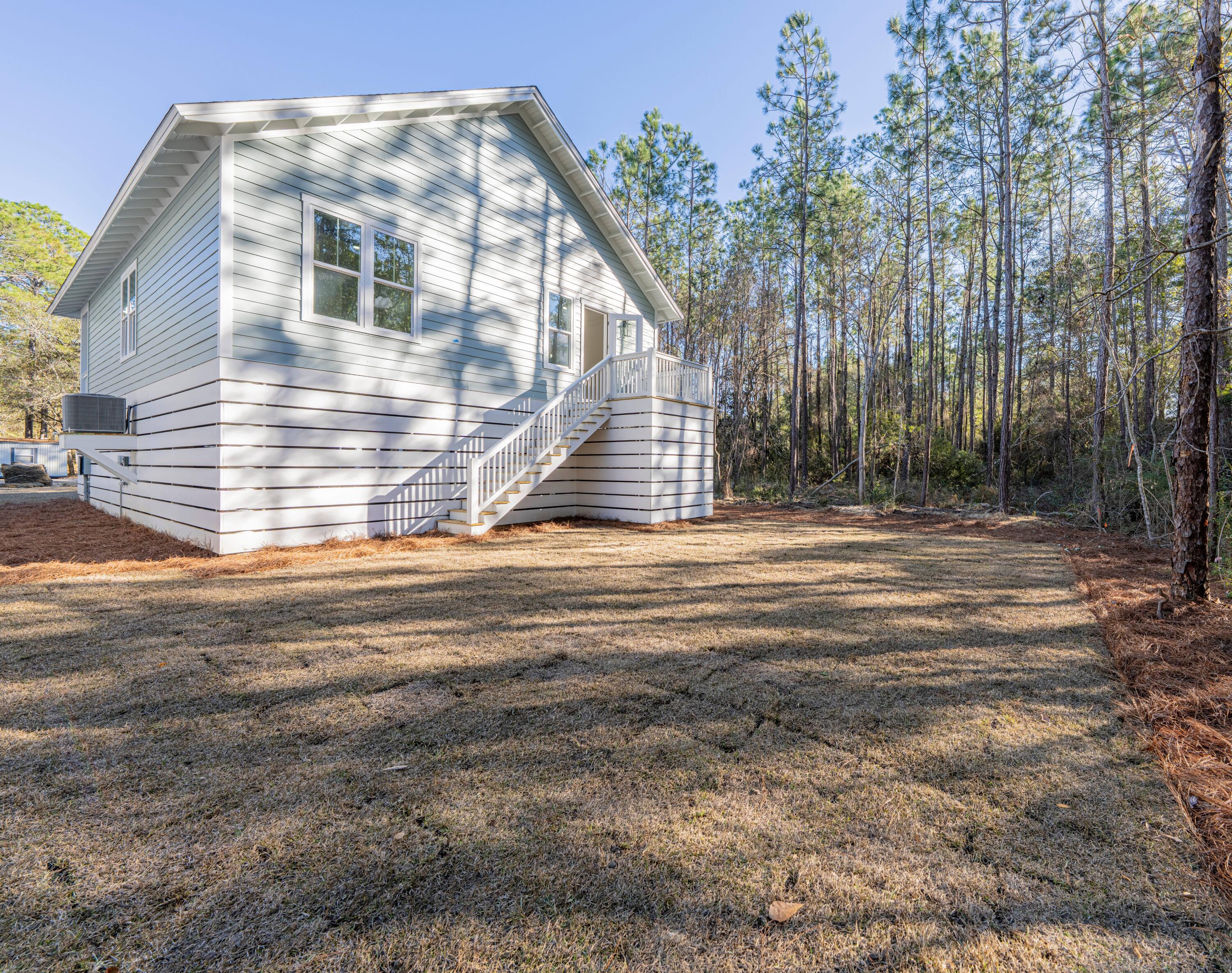 142 4th Street Santa Rosa Beach, FL 32459 - Photo 21 of 26 a view of a house with a yard