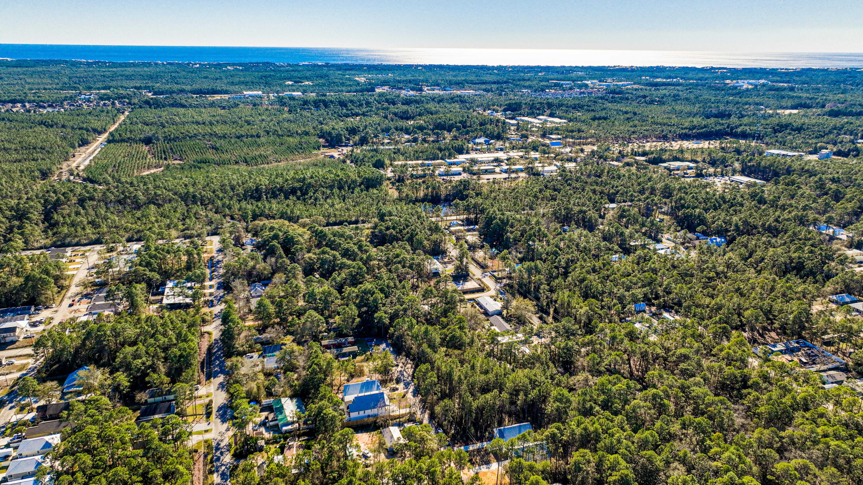 142 4th Street Santa Rosa Beach, FL 32459 - Photo 26 of 26 an aerial view of residential houses with outdoor space and trees