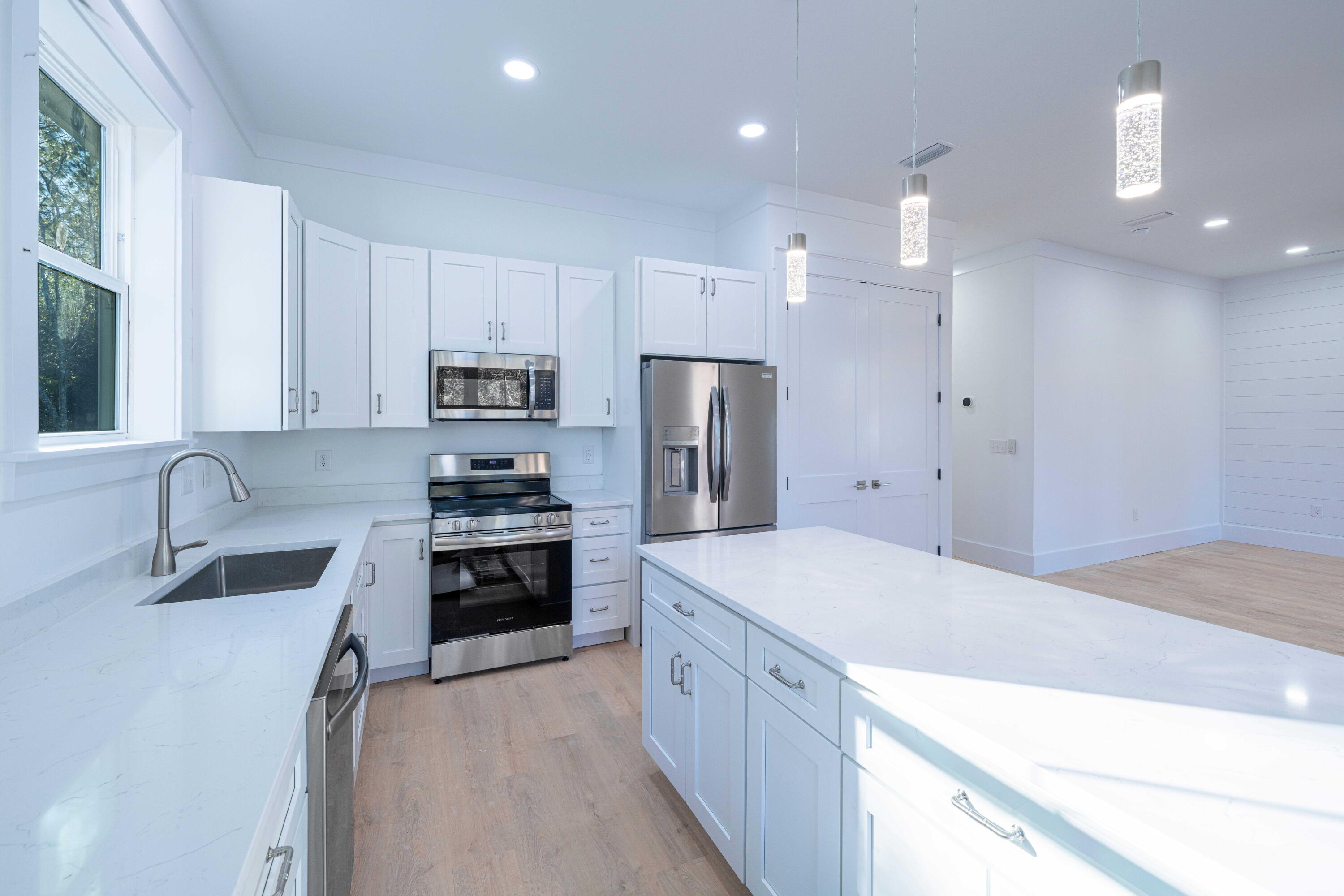142 4th Street Santa Rosa Beach, FL 32459 - Photo 8 of 26 a large kitchen with cabinets stainless steel appliances and a counter space