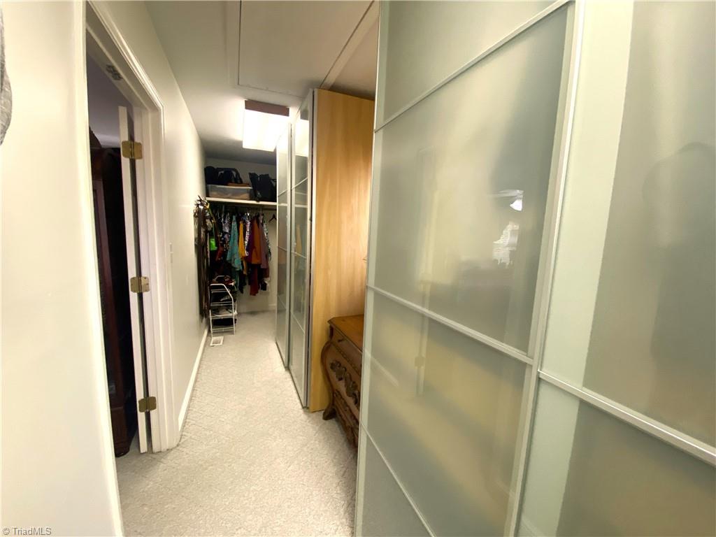 1350 Bethania-Rural Hall Road Winston-Salem, NC 27106 - Photo 21 of 29 If you like a lot of closet space (and who doesn't) you will be dazzled by this custom built closet that is as long as the entire width of the primary bedroom, over 23 feet.