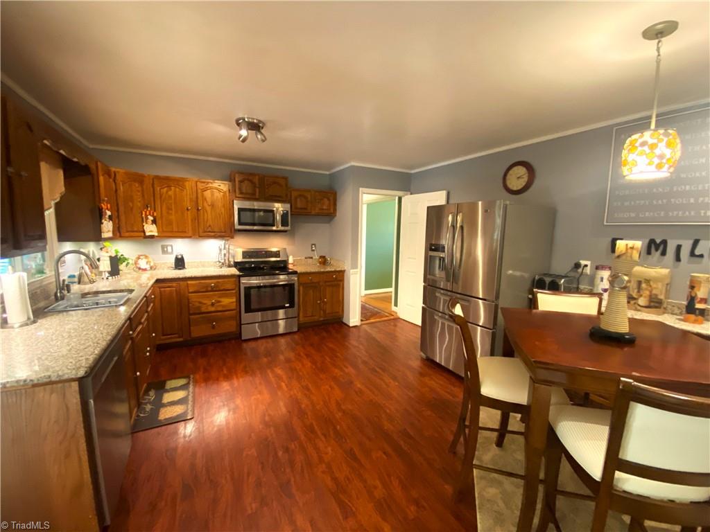 1350 Bethania-Rural Hall Road Winston-Salem, NC 27106 - Photo 3 of 29 Here is the kitchen. Notice the granite counters and stainless steel appliances.