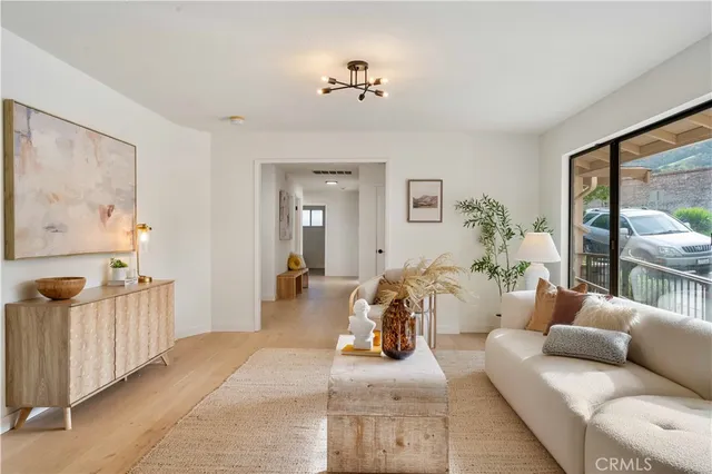 a kitchen with stainless steel appliances granite countertop a refrigerator and a stove top oven with wooden floor