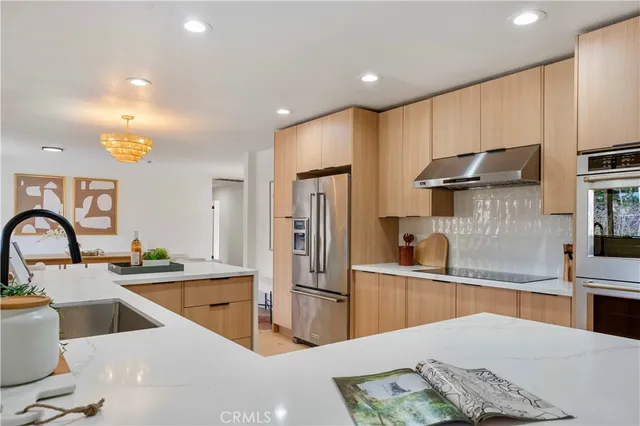 a bedroom with bed and a chandelier