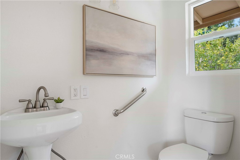 931 Camino Ramon Danville, CA 94526 - Photo 42 of 67 a bathroom with a toilet sink and mirror