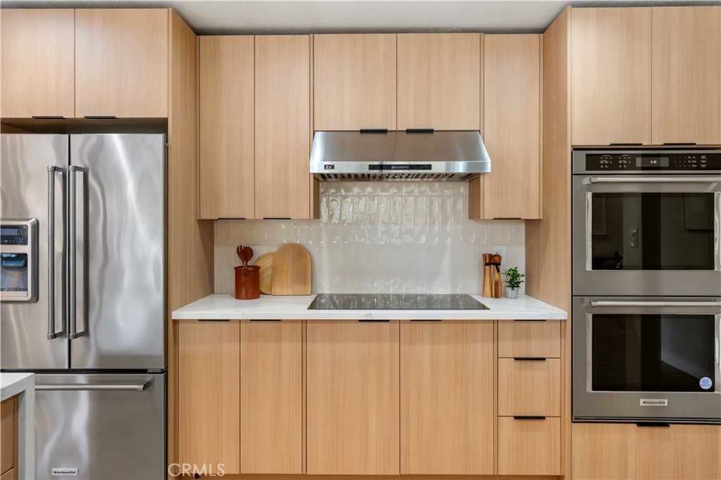 931 Camino Ramon Danville, CA 94526 - Photo 9 of 67 a kitchen with stainless steel appliances granite countertop a refrigerator a stove and a sink with wooden floor