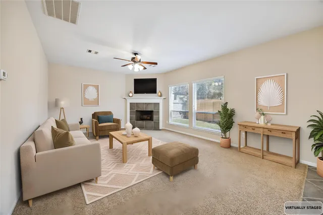 a living room with furniture a fireplace and a flat screen tv