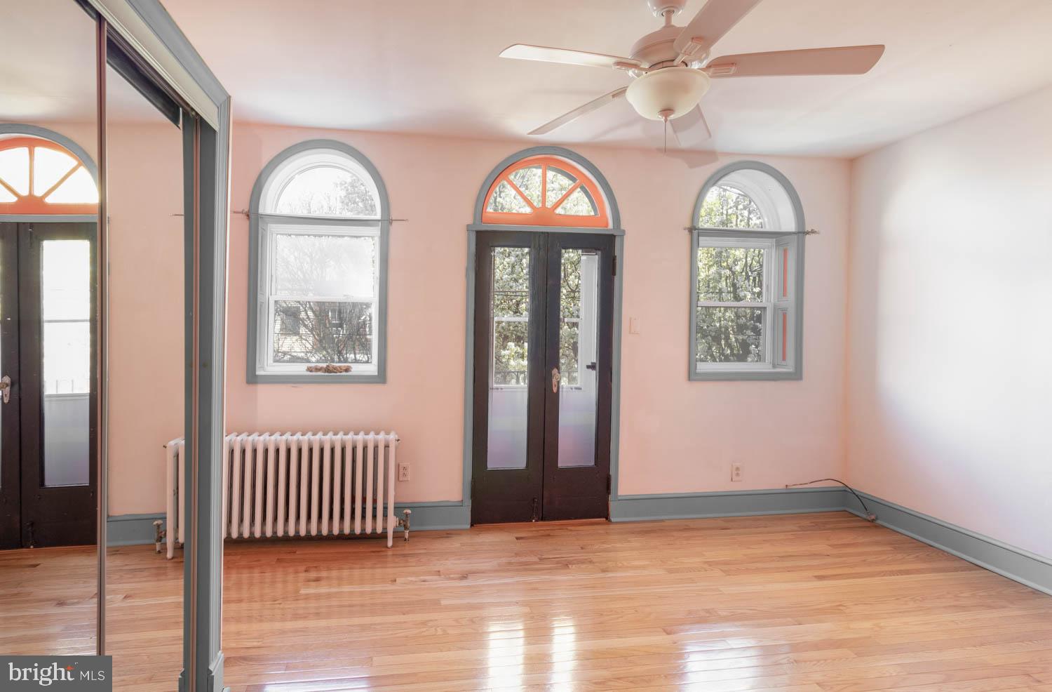 820 Tasker Street Philadelphia, PA 19148 - Photo 11 of 25 an empty room with wooden floor fan and windows
