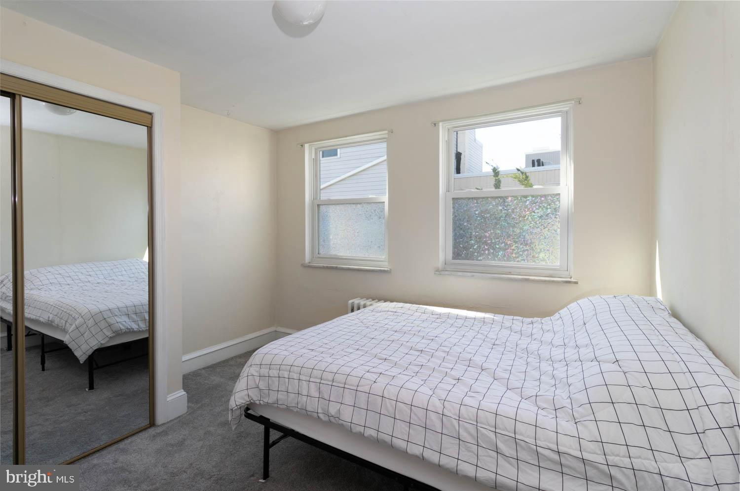 820 Tasker Street Philadelphia, PA 19148 - Photo 18 of 25 a bedroom with a bed and a window