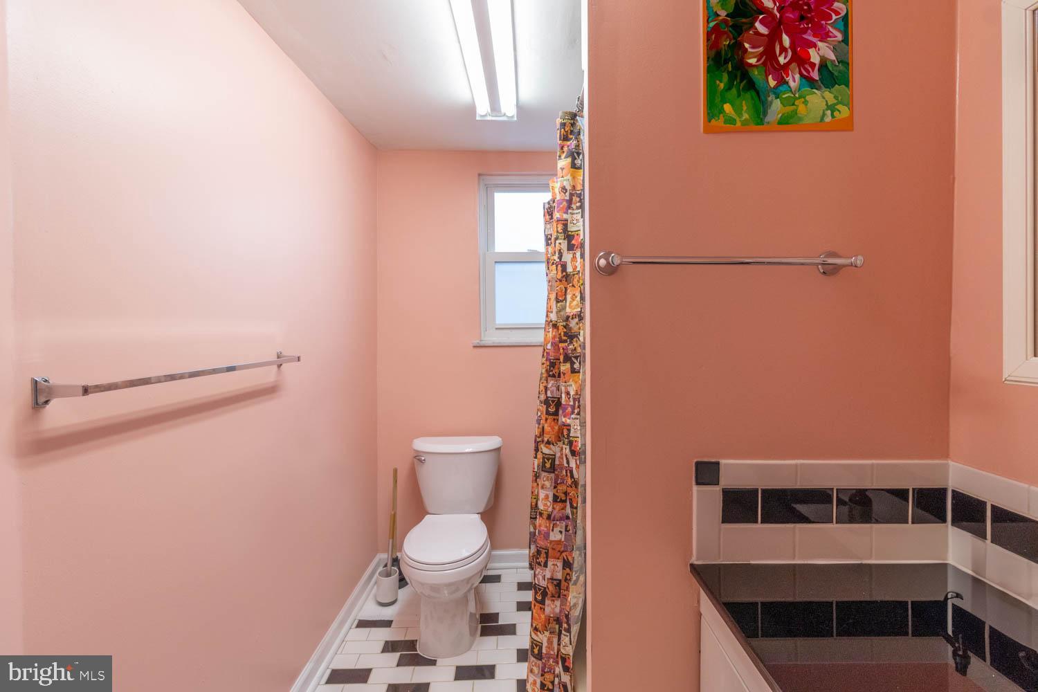820 Tasker Street Philadelphia, PA 19148 - Photo 19 of 25 a bathroom with a toilet and a shower curtain