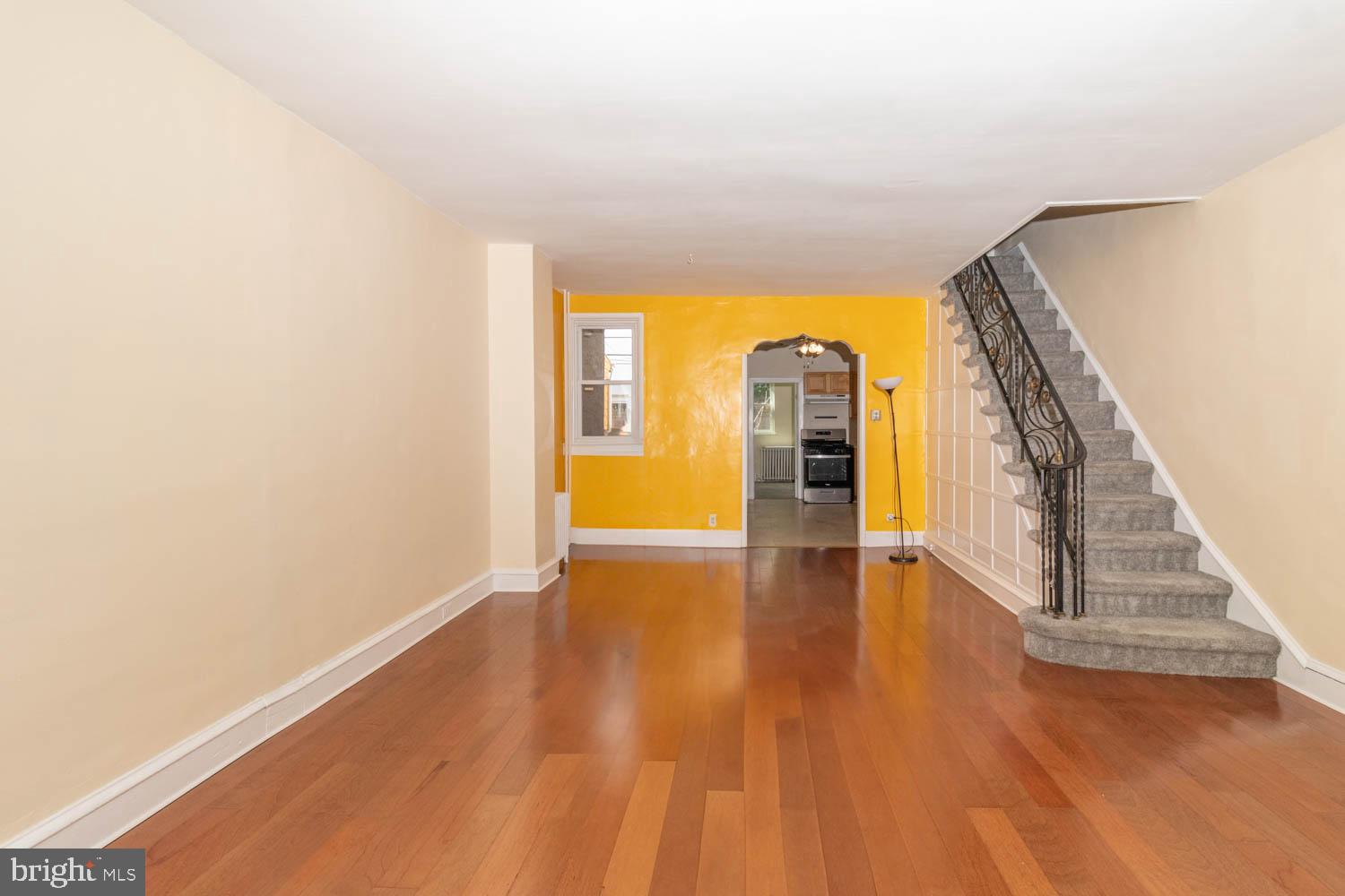 820 Tasker Street Philadelphia, PA 19148 - Photo 7 of 25 a view of an empty room with wooden floor and a window