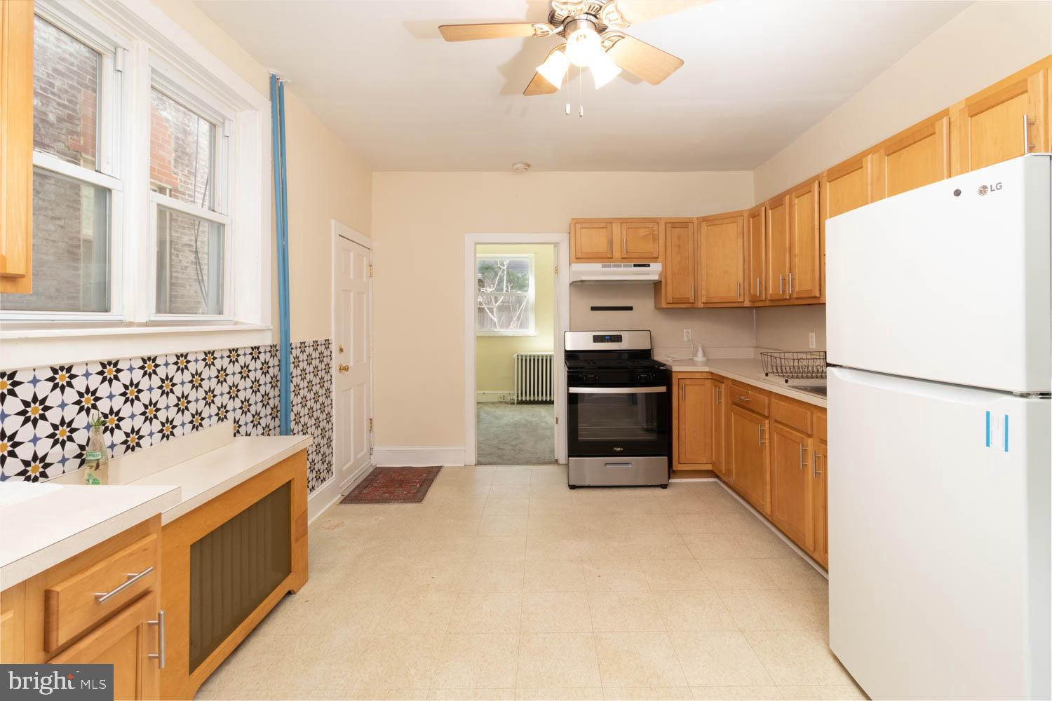 820 Tasker Street Philadelphia, PA 19148 - Photo 8 of 25 a kitchen with stainless steel appliances a refrigerator sink and cabinets