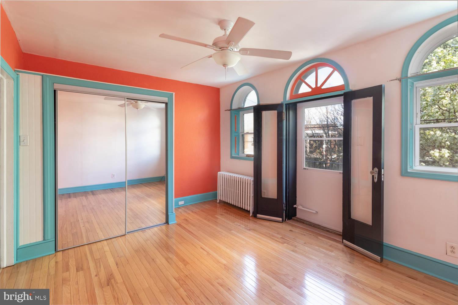 820 Tasker Street Philadelphia, PA 19148 - Photo 10 of 25 an empty room with wooden floor closet and windows