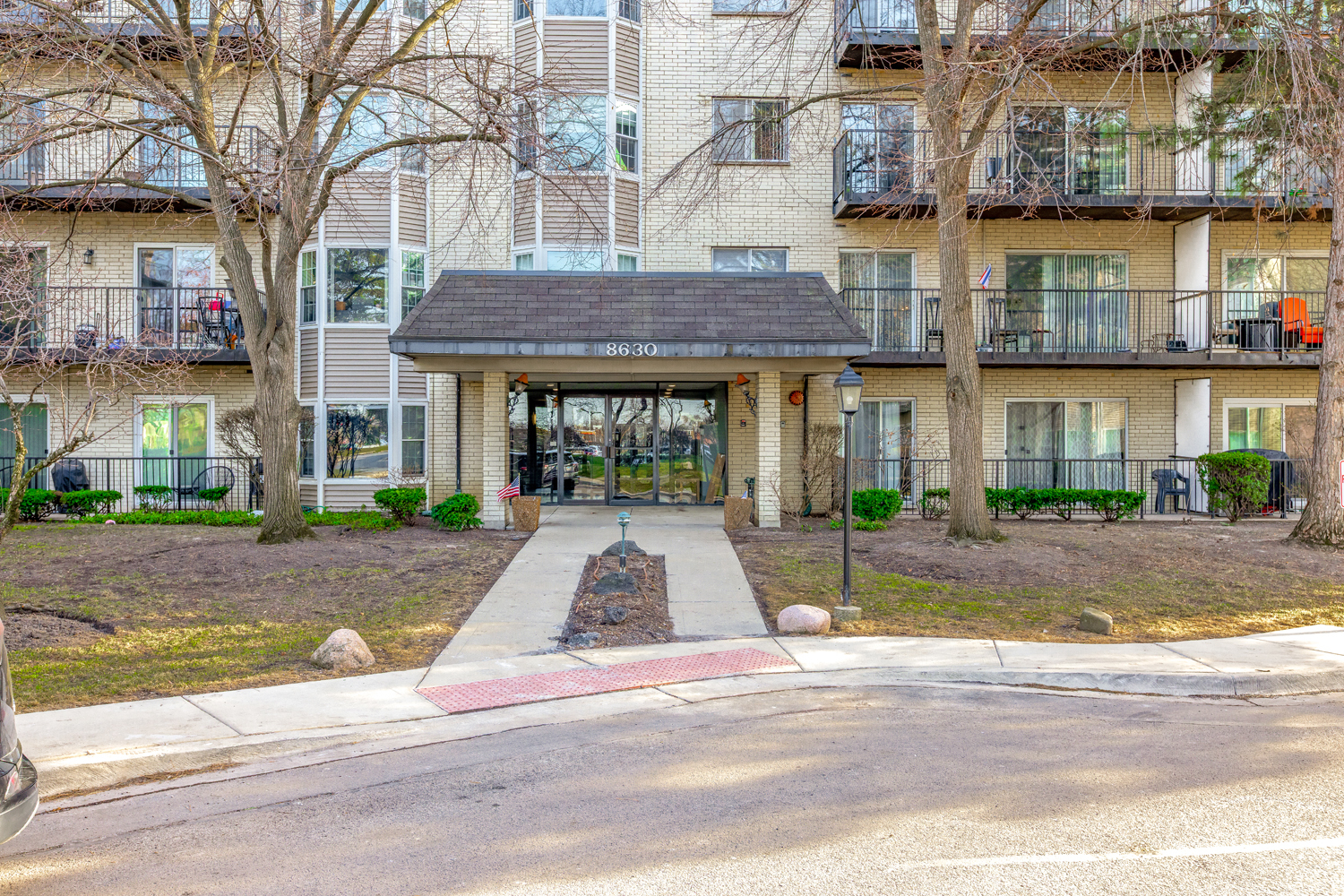 a view of a brick building next to a yard