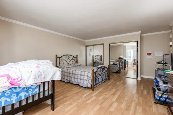 a bedroom with two beds and a dresser