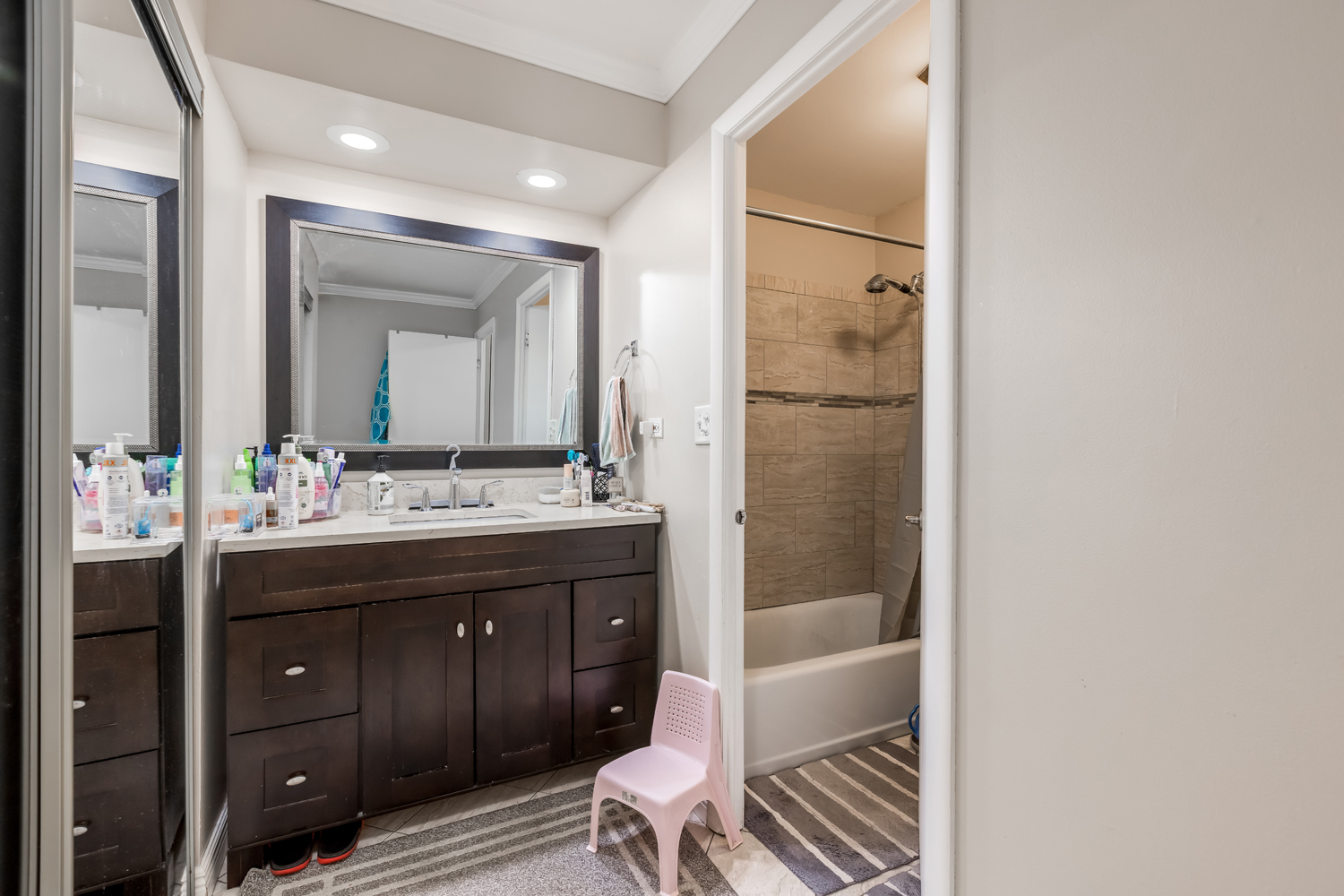 8630 Waukegan Road, Unit 317 Morton Grove, IL 60053 - Photo 13 of 15 a bathroom with a bathtub shower sink vanity and toilet