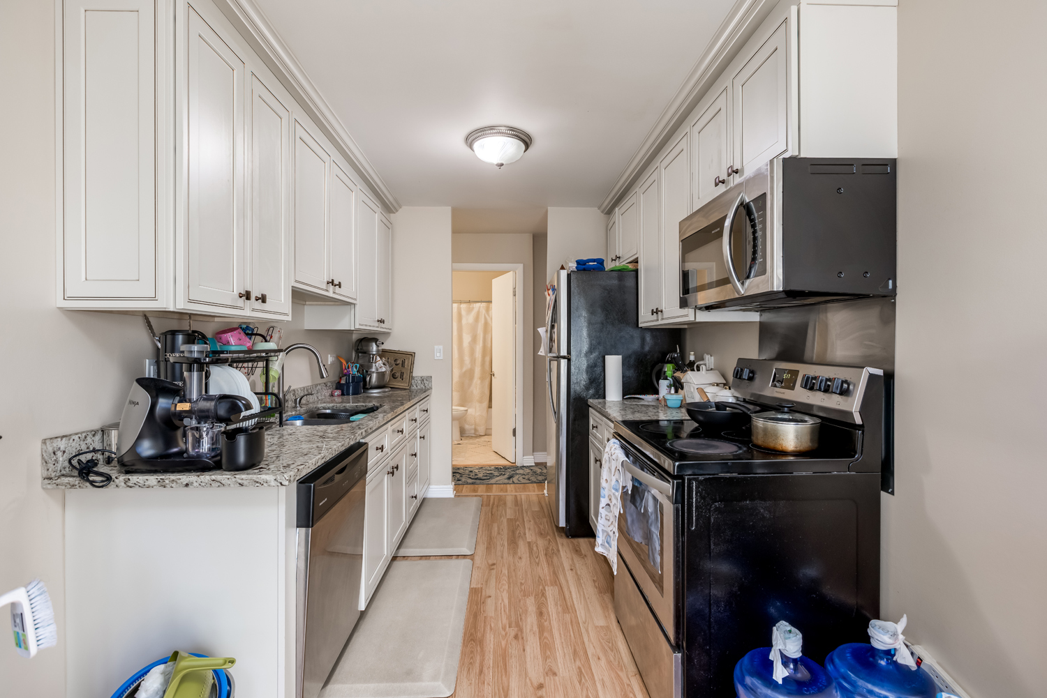 8630 Waukegan Road, Unit 317 Morton Grove, IL 60053 - Photo 9 of 15 a kitchen with stainless steel appliances granite countertop a stove sink and cabinets