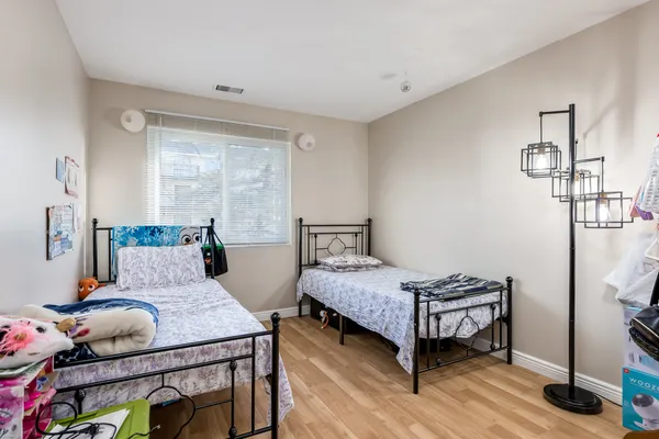 a bedroom with a bed table and a window