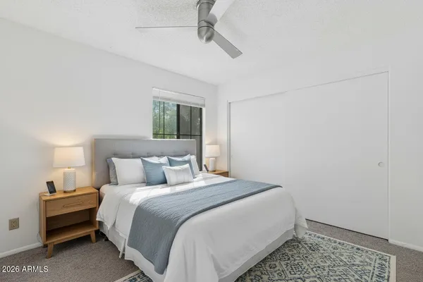 a bedroom with a bed and a night stand