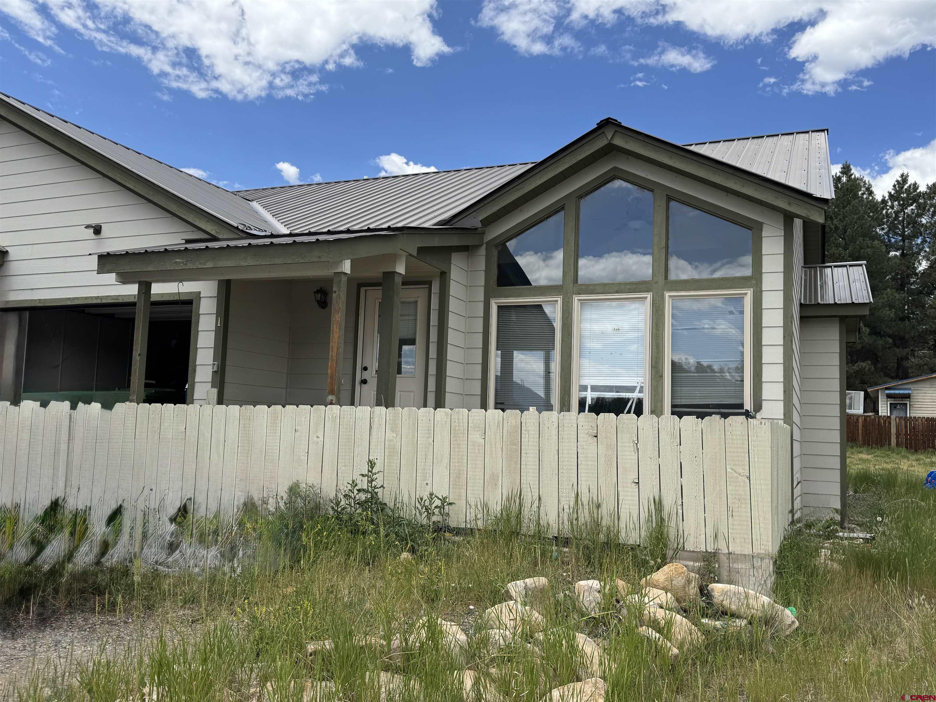 165 Butte Drive Pagosa Springs, CO 81147 - Photo 2 of 6 a front view of a house with a yard