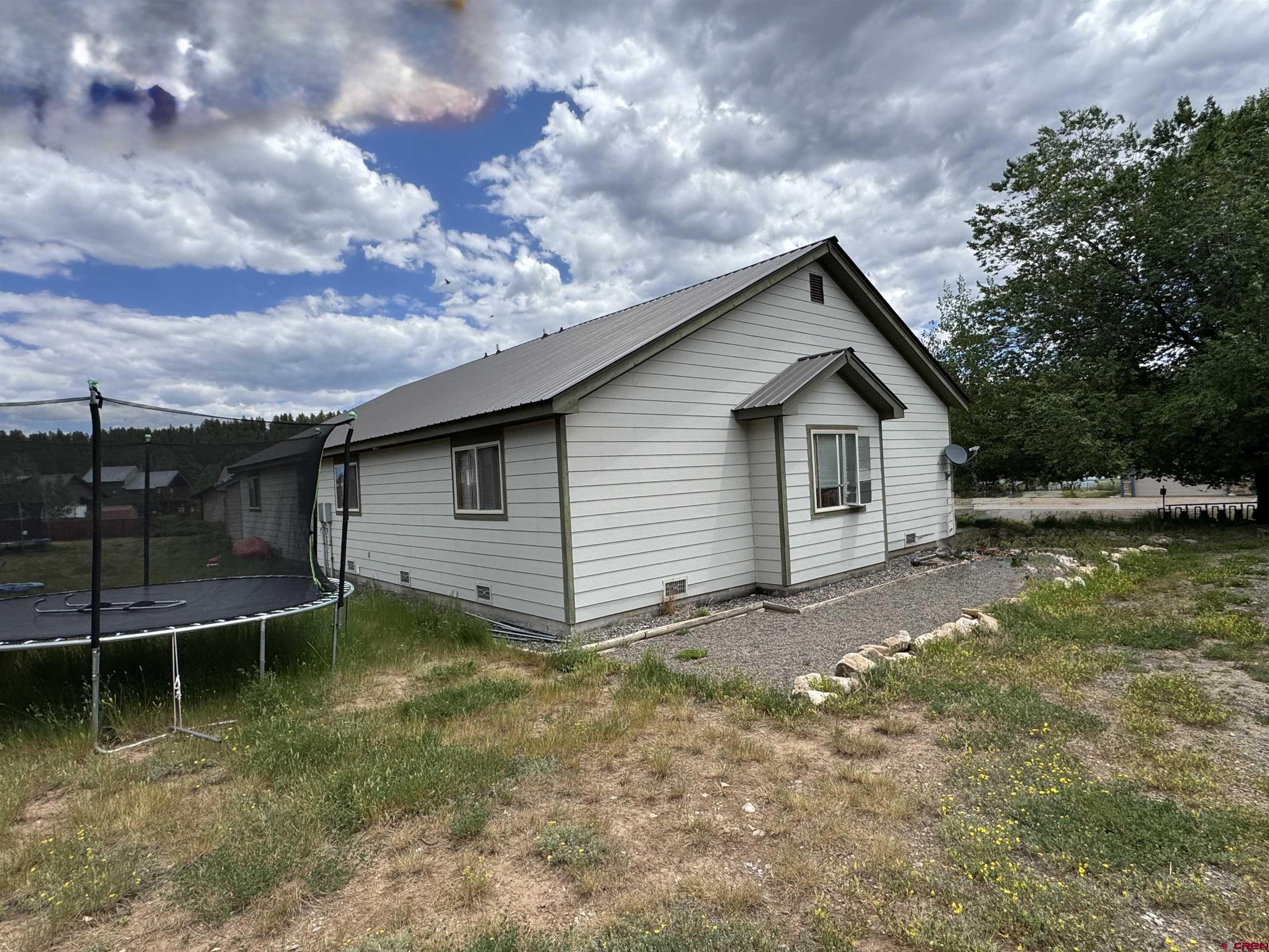 165 Butte Drive Pagosa Springs, CO 81147 - Photo 4 of 6 a view of a backyard with large trees