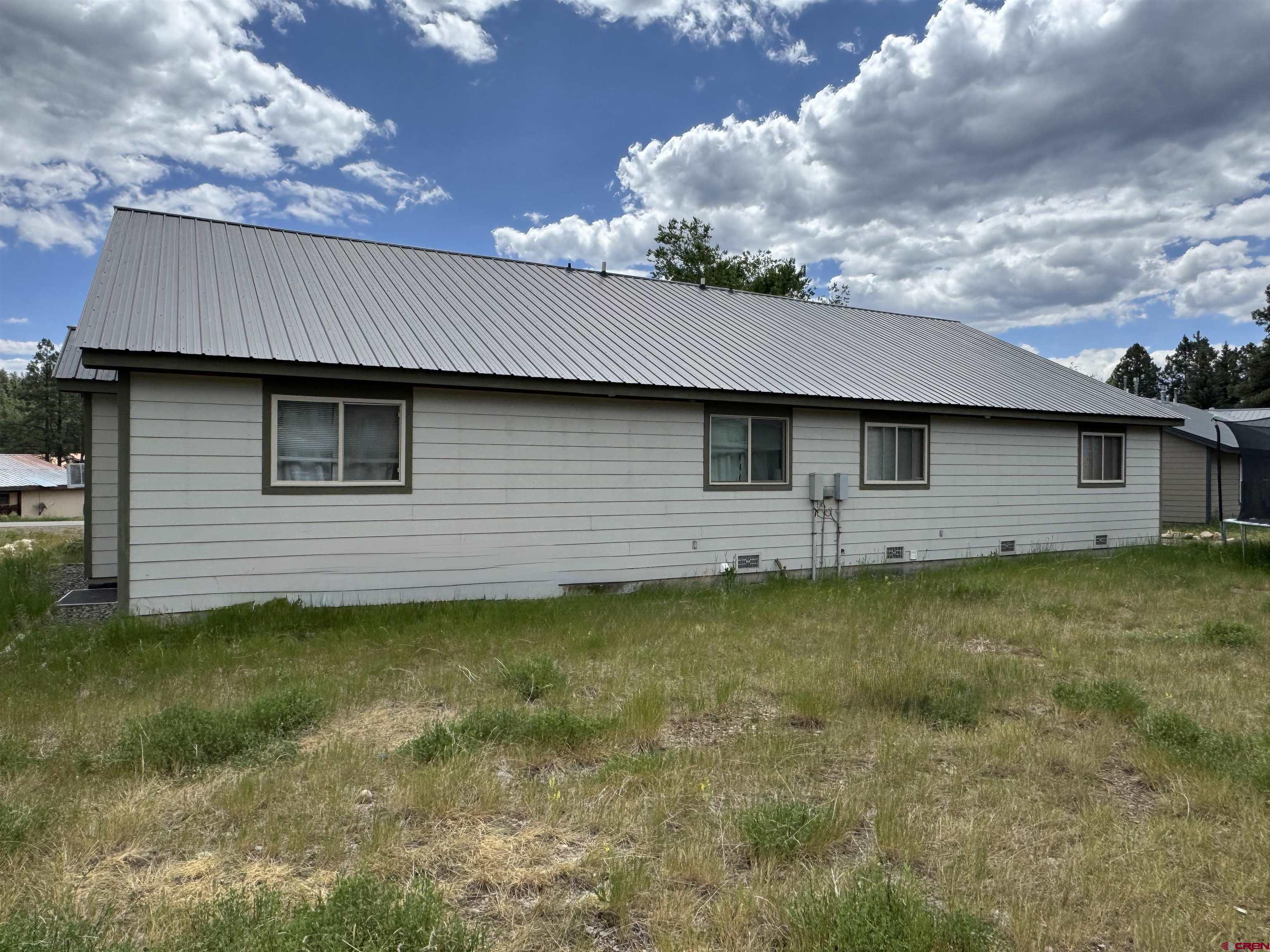 165 Butte Drive Pagosa Springs, CO 81147 - Photo 5 of 6 a backyard of a house with lots of green space
