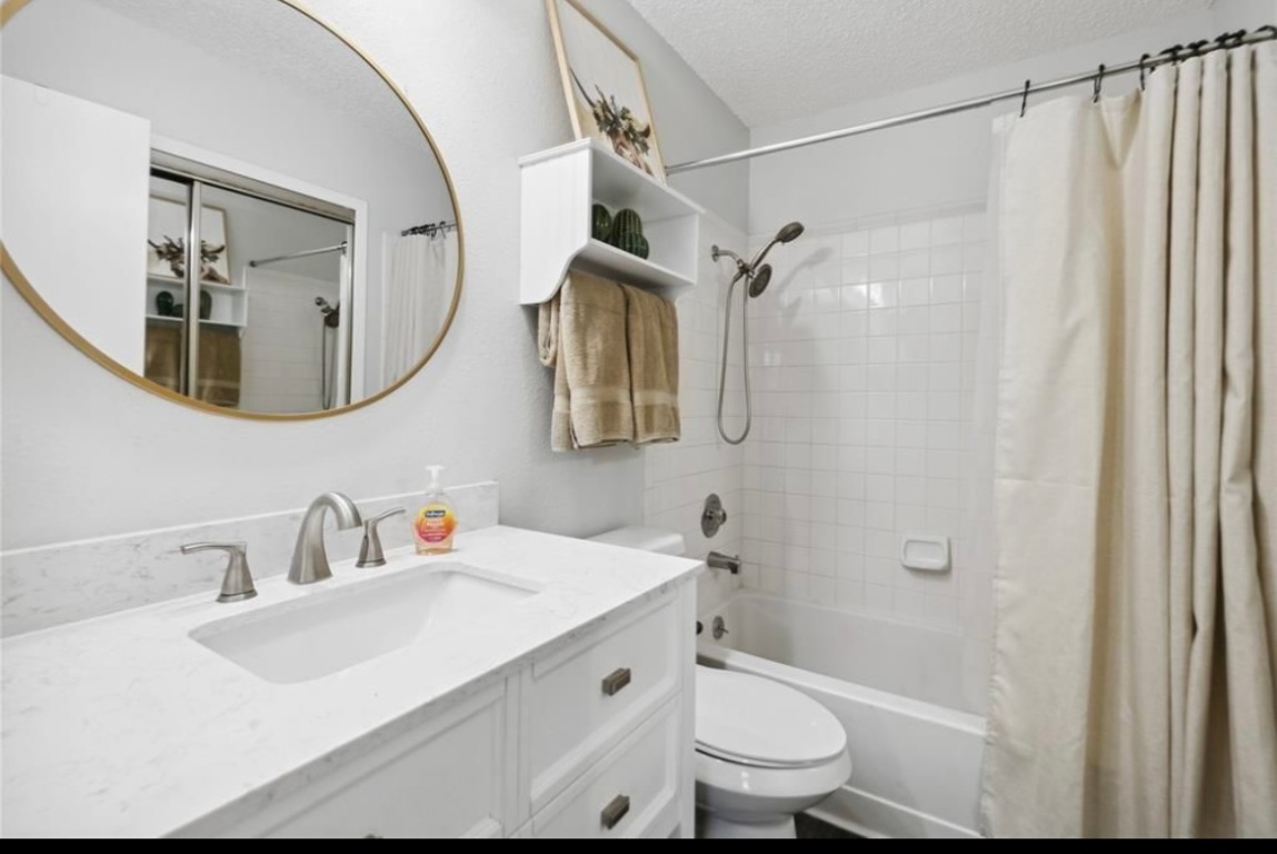 11404 Walnut Ridge Drive, Unit 10 Austin, TX 78753 - Photo 12 of 12 a bathroom with a sink toilet and shower