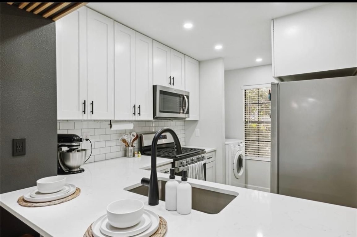 11404 Walnut Ridge Drive, Unit 10 Austin, TX 78753 - Photo 2 of 12 a kitchen with a sink a stove and a refrigerator